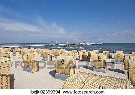Picture - "Beach chairs on the beach, pier at back, Kellenhusen, Baltic Sea, Schleswig-Holstein, Germany, Europe". Fotosearch