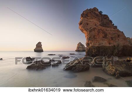 Stock Photo - "Beach with rocks at sunrise, Lagos, Portugal, Europe". Fotosearch