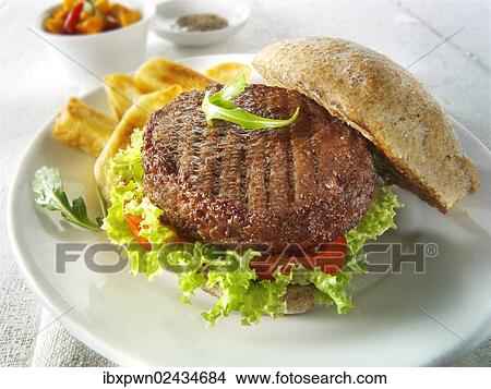 Beef burger in a wholemeal bun with salad and french fries View Large Photo Image Picture - Beef burger in a wholemeal bun with salad and french fries. Fotosearch