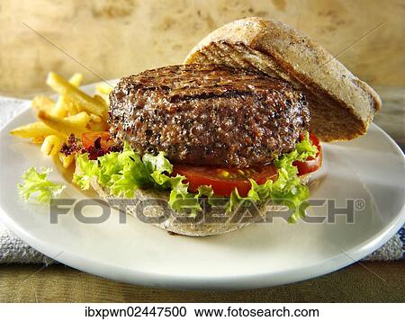 Beef burger in a wholemeal bun with chips View Large Photo Image Stock Image - Beef burger in a wholemeal bun with chips. Fotosearch