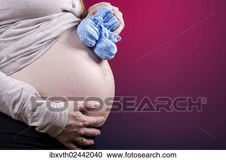 Stock Image - Belly of a pregnant woman. Fotosearch