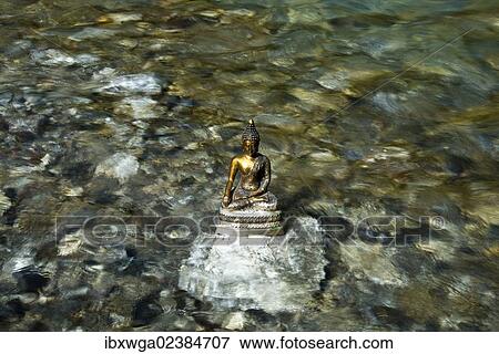 "Bhumispara mudra, Buddha Gautama at the moment of enlightenment, statue in a mountain stream, Oytal Valley, Allgaeu, Bavaria, Germany, Europe, PublicGround, Europe" View Large Photo Image Stock Photo - "Bhumispara mudra, Buddha Gautama at the moment of enlightenment, statue in a mountain stream, Oytal Valley, Allgaeu, Bavaria, Germany, Europe, PublicGround, Europe". Fotosearch
