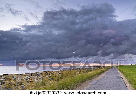 Stock Image - "Bike path or walking trail along the North Sea, Wremer Tief, Wremen, Lower Saxony, Germany, Europe". Fotosearch
