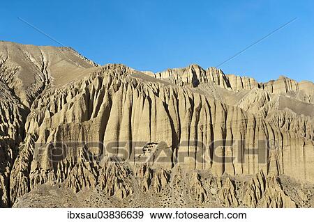 "Bizarre erosion landscape with prehistoric caves in the rocks, near Ghami, Upper Mustang, Lo, Himalayas, Nepal, Asia" View Large Photo Image Stock Photo - "Bizarre erosion landscape with prehistoric caves in the rocks, near Ghami, Upper Mustang, Lo, Himalayas, Nepal, Asia". Fotosearch
