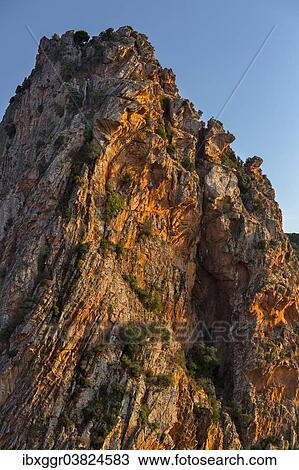 Stock Image - "Bizarre rock erosions in the evening light, Calanche, Les Calanches de Piana, Corse-du-Sud, Corsica, France, Europe". Fotosearch
