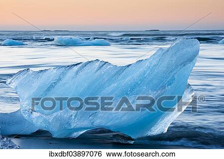 "Block of ice on a black beach being lapped by the sea, Jokulsarlon Glacier Lagoon, Vatnajokull Glacier, Austurland, East Iceland, Iceland, Europe" View Large Photo Image Stock Photograph - "Block of ice on a black beach being lapped by the sea, Jokulsarlon Glacier Lagoon, Vatnajokull Glacier, Austurland, East Iceland, Iceland, Europe". Fotosearch