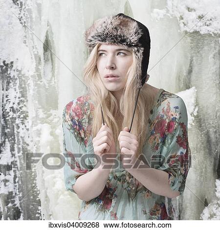"Blond woman summer dress and winter hat, in front of an ice-covered mountain" View Large Photo Image Stock Photo - "Blond woman summer dress and winter hat, in front of an ice-covered mountain". Fotosearch