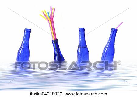 Blue bottles with coloured straws floating in water View Large Photo Image Stock Photo - Blue bottles with coloured straws floating in water. Fotosearch
