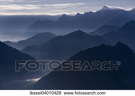 Stock Photo - "Blue hour with mountain peaks of the Ammer Mountains, Mt. Zugspitze at the back, Reutte, Ausserfern, Tyrol, Austria, Europe". Fotosearch
