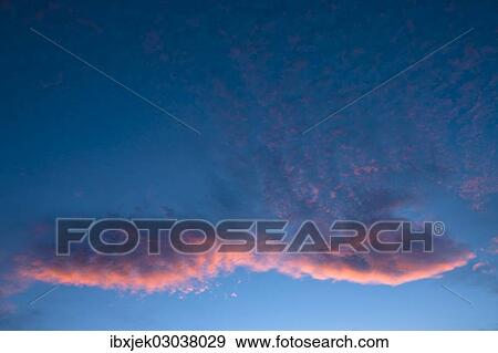 Stock Photo - "Blue sky with a pink cloud, sunset". Fotosearch