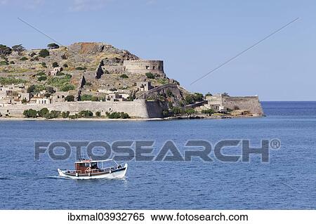 Stock Photography - "Boat off the Spinalonga peninsula, Kalidon, Elounda Gulf, Crete, Greece, Europe". Fotosearch