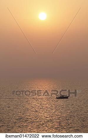Stock Image - "Boat on the sea, sunset, Kovalam, Kerala, southern India, India, Asia". Fotosearch