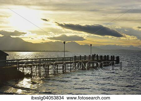 "Boathouse with jetty at sunset on Lake Chiemsee, Chiemgau and Schliersee Alps silhouetted, in Chieming, Chiemgau, Alpine Foreland, Bavaria, Germany, Europe" View Large Photo Image Picture - "Boathouse with jetty at sunset on Lake Chiemsee, Chiemgau and Schliersee Alps silhouetted, in Chieming, Chiemgau, Alpine Foreland, Bavaria, Germany, Europe". Fotosearch