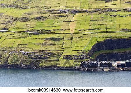 Stock Image - "Boathouses and meadows, Vestmanna, Streymoy, Faroe Islands, Denmark, Europe". Fotosearch