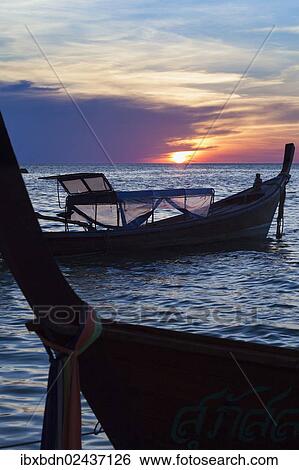 "Boats at sunset from sunset beach on Ko Lipe, Ko Li Pe or Koh Li Pe island, Thailand, Asia" View Large Photo Image Stock Photograph - "Boats at sunset from sunset beach on Ko Lipe, Ko Li Pe or Koh Li Pe island, Thailand, Asia". Fotosearch
