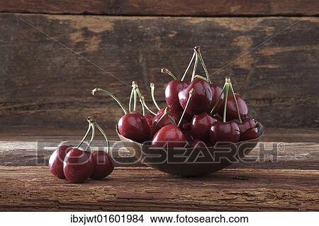 Bowl of Cherries (Prunus) in front of rustic wood View Large Photo Image Picture - Bowl of Cherries (Prunus) in front of rustic wood. Fotosearch