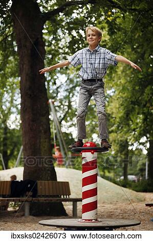 "Boy, 10 years, balancing on balancing item on playground" View Large Photo Image Stock Image - "Boy, 10 years, balancing on balancing item on playground". Fotosearch