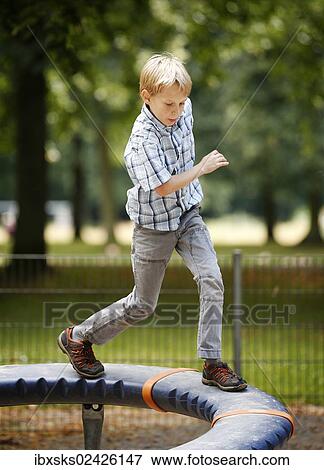 "Boy, 10 years, playground, balancing on playground equipment Supernova" View Large Photo Image Stock Photo - "Boy, 10 years, playground, balancing on playground equipment Supernova". Fotosearch