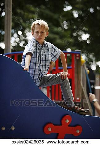 "Boy, 10 years, playground, posing on a toy boat" View Large Photo Image Stock Photography - "Boy, 10 years, playground, posing on a toy boat". Fotosearch