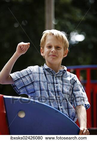 "Boy, 10 years, posing on a toy boat on a playground" View Large Photo Image Stock Image - "Boy, 10 years, posing on a toy boat on a playground". Fotosearch