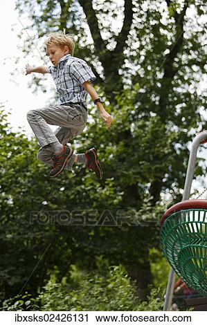 "Boy, 10 years, romping in a playground, jumping out of a nest swing" View Large Photo Image Stock Image - "Boy, 10 years, romping in a playground, jumping out of a nest swing". Fotosearch