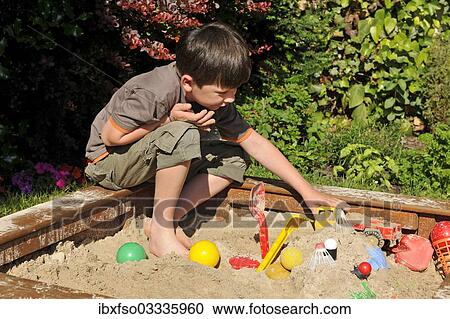"Boy, 7 years, playing in sandpit, Lower Saxony, Germany, Europe" View Large Photo Image Stock Image - "Boy, 7 years, playing in sandpit, Lower Saxony, Germany, Europe". Fotosearch