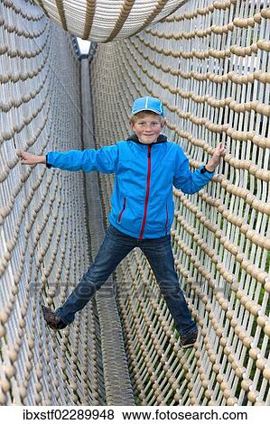 "Boy, 8, standing in a tunnel made from ropes" View Large Photo Image Stock Photo - "Boy, 8, standing in a tunnel made from ropes". Fotosearch