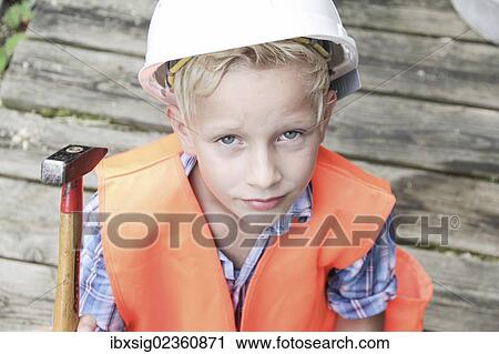 "Boy dressed as a construction worker with a hard hat, a safety vest and a hammer" View Large Photo Image Stock Image - "Boy dressed as a construction worker with a hard hat, a safety vest and a hammer". Fotosearch