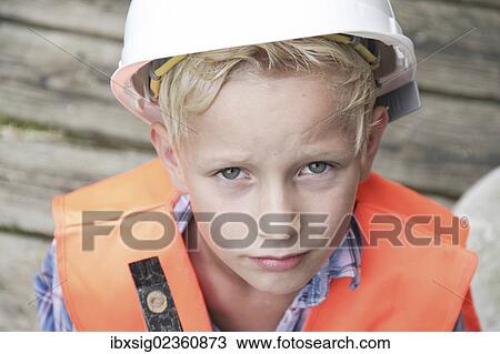 "Boy dressed as a construction worker with a hard hat, a safety vest and a hammer" View Large Photo Image Stock Image - "Boy dressed as a construction worker with a hard hat, a safety vest and a hammer". Fotosearch
