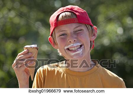 Stock Photo - Boy eating an ice cream cone. Fotosearch