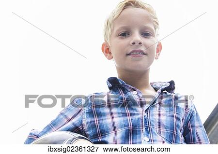 Boy holding a ball View Large Photo Image Stock Photo - Boy holding a ball. Fotosearch
