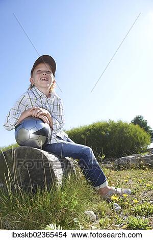 Boy holding a football View Large Photo Image Picture - Boy holding a football. Fotosearch
