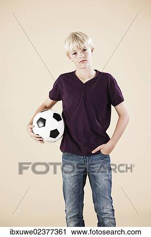 Boy holding a football View Large Photo Image Stock Image - Boy holding a football. Fotosearch