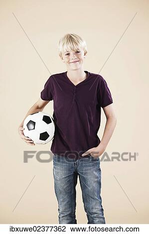 Boy holding a football View Large Photo Image Stock Image - Boy holding a football. Fotosearch