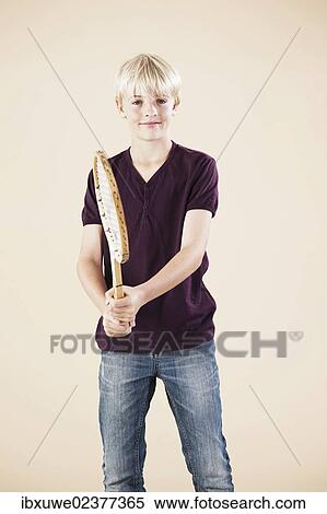 Boy holding a tennis racket View Large Photo Image Stock Photography - Boy holding a tennis racket. Fotosearch