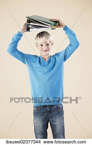 Boy holding folders View Large Photo Image Picture - Boy holding folders. Fotosearch