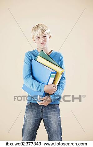 Stock Photo - Boy holding folders. Fotosearch