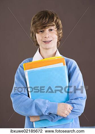 Boy holding school books View Large Photo Image Stock Image - Boy holding school books. Fotosearch