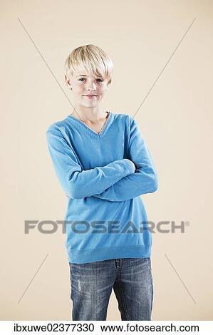 Boy in a blue sweater and jeans View Large Photo Image Stock Image - Boy in a blue sweater and jeans. Fotosearch