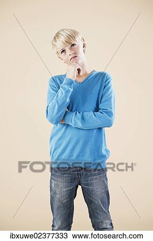 "Boy in a blue sweater and jeans, thoughtful" View Large Photo Image Stock Image - "Boy in a blue sweater and jeans, thoughtful". Fotosearch