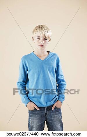 Boy in a blue sweater and jeans View Large Photo Image Stock Image - Boy in a blue sweater and jeans. Fotosearch