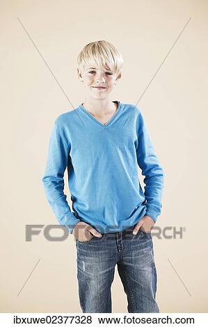 Boy in a blue sweater and jeans View Large Photo Image Stock Photo - Boy in a blue sweater and jeans. Fotosearch