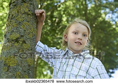 Stock Photo - Boy in a forest. Fotosearch