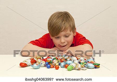 Boy in front of Christmas candies View Large Photo Image Stock Photo - Boy in front of Christmas candies. Fotosearch