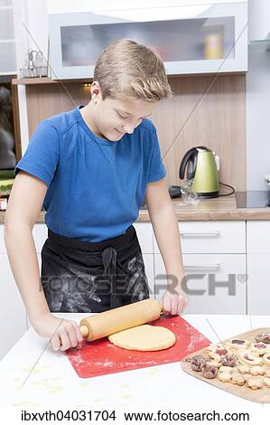 "Boy in the kitchen, making xmas cookies" View Large Photo Image Picture - "Boy in the kitchen, making xmas cookies". Fotosearch