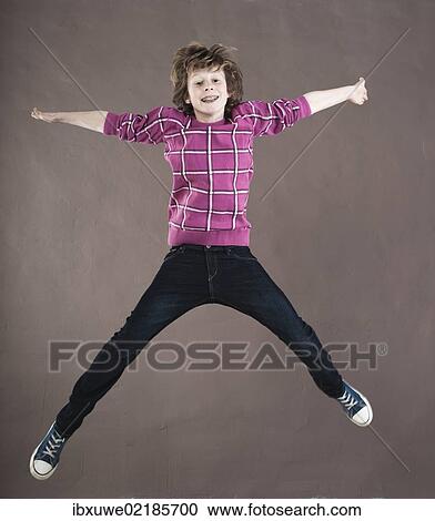 Boy leaping into the air View Large Photo Image Stock Image - Boy leaping into the air. Fotosearch