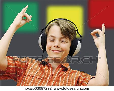 Boy listening to music with headphones View Large Photo Image Stock Image - Boy listening to music with headphones. Fotosearch