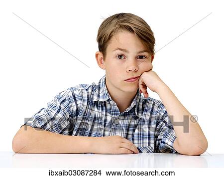 "Boy, looking serious, with his hand supporting his head" View Large Photo Image Picture - "Boy, looking serious, with his hand supporting his head". Fotosearch