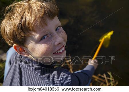 "Boy on a lake with fishing net, Wandersleben, Thuringia, Germany, Europe" View Large Photo Image Stock Photograph - "Boy on a lake with fishing net, Wandersleben, Thuringia, Germany, Europe". Fotosearch