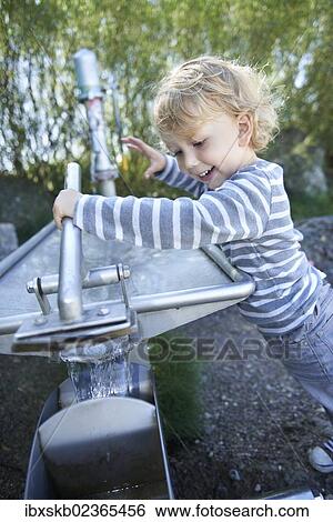 Boy playing with water View Large Photo Image Stock Photograph - Boy playing with water. Fotosearch